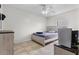 Simple bedroom with tiled floors, ceiling fan, and minimalistic furnishings at 621 Bluebill Ln, Poinciana, FL 34759