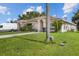 Beautiful home featuring manicured lawns and mature trees providing ample shade at 621 Bluebill Ln, Poinciana, FL 34759