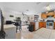 Open concept kitchen with stainless steel appliances connected to living room at 621 Bluebill Ln, Poinciana, FL 34759