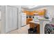 Galley kitchen featuring wooden cabinets, white appliances, and tile flooring at 621 Bluebill Ln, Poinciana, FL 34759