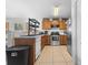 Well-lit kitchen features stainless steel appliances and wooden cabinets at 621 Bluebill Ln, Poinciana, FL 34759