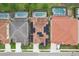 Bird's eye view showing rooftops, solar panels, fenced-in yards, and private swimming pools at 7033 Oakwood St, Davenport, FL 33837