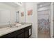 Bathroom with dual sinks, granite countertops, and a separate shower, providing a luxurious experience at 7033 Oakwood St, Davenport, FL 33837