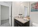 Bathroom featuring a granite vanity, dark cabinets, and ample lighting at 7033 Oakwood St, Davenport, FL 33837