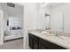 Bathroom with dual sinks and modern fixtures, offering a clean and functional space with natural light at 7033 Oakwood St, Davenport, FL 33837