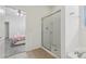 Bathroom featuring a glass-enclosed shower next to the main bedroom at 7033 Oakwood St, Davenport, FL 33837