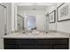 Double sink vanity featuring granite countertop and views into the adjacent room at 7033 Oakwood St, Davenport, FL 33837