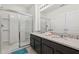 Bathroom features a glass shower door and dual sinks with granite countertops at 7033 Oakwood St, Davenport, FL 33837