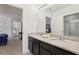 Bathroom featuring a large mirror, granite countertop, and views into the hallway at 7033 Oakwood St, Davenport, FL 33837