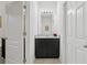 Bathroom featuring a granite vanity, dark cabinets, and ample lighting at 7033 Oakwood St, Davenport, FL 33837