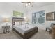Bedroom featuring a comfortable bed, a window, and stylish decor at 7033 Oakwood St, Davenport, FL 33837