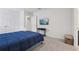 Neutral bedroom with double door closet, television, and plush carpet at 7033 Oakwood St, Davenport, FL 33837