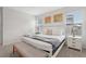 Bright bedroom with a white frame bed, soft grey carpet, and colorful wall art at 7033 Oakwood St, Davenport, FL 33837