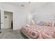 Bright bedroom features a ceiling fan, plush carpeting, and a tastefully decorated bed with decorative pillows at 7033 Oakwood St, Davenport, FL 33837