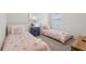 Cozy bedroom featuring twin beds with whimsical decor, creating a comfortable and inviting atmosphere at 7033 Oakwood St, Davenport, FL 33837