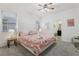 Bedroom boasts soft natural light, a ceiling fan, and a cozy ambiance with its stylish bed and linens at 7033 Oakwood St, Davenport, FL 33837
