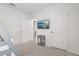 Bright bedroom featuring a TV, with an open doorway enhancing the room's spacious feel at 7033 Oakwood St, Davenport, FL 33837