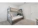 Neutral bedroom with a bunk bed and simple furnishings, offering a cozy and functional space at 7033 Oakwood St, Davenport, FL 33837