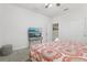 This bedroom features a ceiling fan, carpeting, and a stylishly appointed bed with soft linens and contemporary decor at 7033 Oakwood St, Davenport, FL 33837