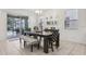 Dining area featuring modern table with seating for six and sliding glass doors at 7033 Oakwood St, Davenport, FL 33837