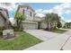 Charming two-story home with well-manicured lawn and two car garage at 7033 Oakwood St, Davenport, FL 33837