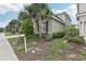 Exterior showcasing landscaped front yard with palm trees at 7033 Oakwood St, Davenport, FL 33837