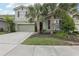 Charming two-story home with well-manicured lawn and two car garage at 7033 Oakwood St, Davenport, FL 33837