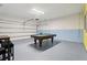 Finished garage with a pool table, game table, and ample space for recreation and entertainment at 7033 Oakwood St, Davenport, FL 33837