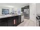 Kitchen featuring stainless steel appliances, including a dishwasher and refrigerator, with granite countertops at 7033 Oakwood St, Davenport, FL 33837