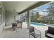 Screened lanai with outdoor dining and lounge area, adjacent to a private pool and spa for resort-style living at 7033 Oakwood St, Davenport, FL 33837
