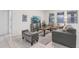 Inviting living room featuring neutral decor, tile flooring, and ample natural light at 7033 Oakwood St, Davenport, FL 33837