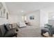 Spacious living room featuring plush seating, a wall-mounted TV, and neutral tones for versatile styling at 7033 Oakwood St, Davenport, FL 33837