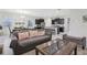Open-concept living space with modern furniture and easy access to kitchen and dining at 7033 Oakwood St, Davenport, FL 33837