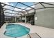 Enjoy the outdoors with this screened-in pool, spa, and covered patio for grilling and entertaining at 7033 Oakwood St, Davenport, FL 33837