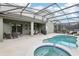 Private screened pool and spa area with comfortable seating and sun loungers, perfect for outdoor relaxation at 7033 Oakwood St, Davenport, FL 33837