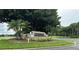 Entrance sign for Bermuda Dunes Luxury Condominiums surrounded by palm trees and lush landscaping at 7350 Westpointe Blvd # 234, Orlando, FL 32835