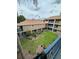 Building courtyard with grass and plants surrounded by apartments at 7350 Westpointe Blvd # 234, Orlando, FL 32835