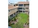 Multi-story condo building with a well-maintained lawn area at 7350 Westpointe Blvd # 234, Orlando, FL 32835