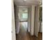 Hallway featuring wood-look flooring, leading to a bedroom with an adjacent laundry closet at 7350 Westpointe Blvd # 234, Orlando, FL 32835