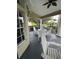 Relaxing patio with white table and chairs looking onto the landscaped community at 7350 Westpointe Blvd # 234, Orlando, FL 32835