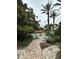 Landscaped community pool area with chairs, tables, umbrellas and walkways at 7350 Westpointe Blvd # 234, Orlando, FL 32835