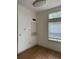 An empty room showcases wood-look flooring and a window with blinds for natural light at 7350 Westpointe Blvd # 234, Orlando, FL 32835