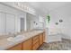 Bathroom featuring double sinks, wood-look floor, and tub at 7744 Country Run Pkwy, Orlando, FL 32818