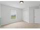 The bedroom is bright, featuring neutral carpet and a double door closet at 7744 Country Run Pkwy, Orlando, FL 32818
