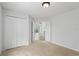 Neutral bedroom features a spacious closet and an open doorway at 7744 Country Run Pkwy, Orlando, FL 32818