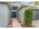 Inviting entryway features a stylish front door, lush landscaping, and a well-maintained walkway at 7744 Country Run Pkwy, Orlando, FL 32818