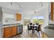 Bright kitchen area features wood cabinets, modern appliances, and a dining nook at 7744 Country Run Pkwy, Orlando, FL 32818