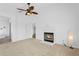 Open living room with fireplace and ceiling fan; neutral walls and carpet at 7744 Country Run Pkwy, Orlando, FL 32818