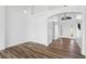 A minimalist living room features hardwood floors, white walls, and an open entrance at 7744 Country Run Pkwy, Orlando, FL 32818
