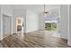 Open concept living room showcases wood floors and sliding glass door access at 7744 Country Run Pkwy, Orlando, FL 32818